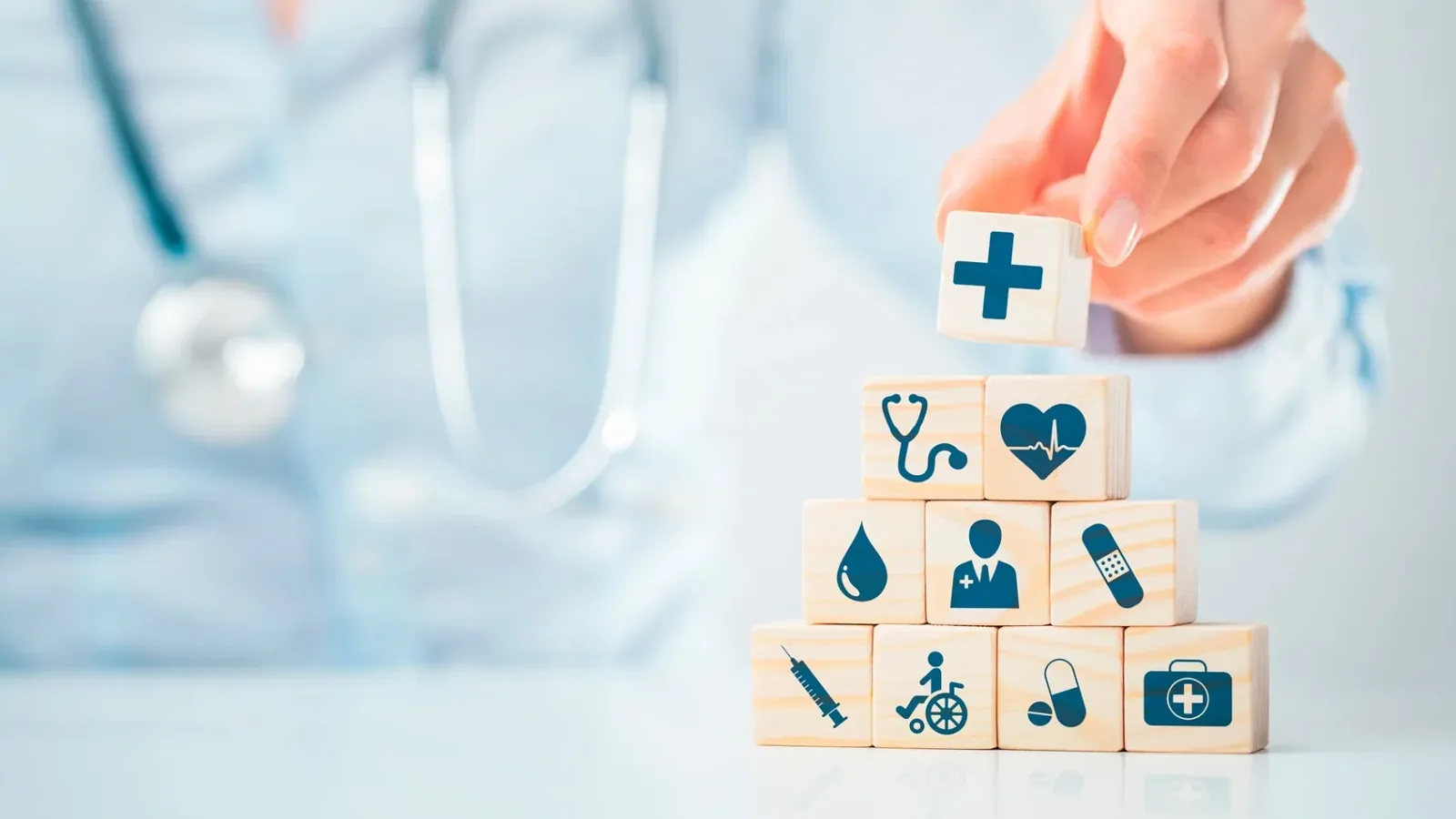 Médico montando blocos com ícones de serviços de saúde